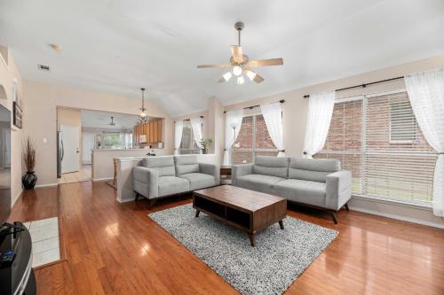 a living room with two couches and a table at Relaxing 3BR 2BA Oasis - Hot Tub & 5 Beds! in The Colony