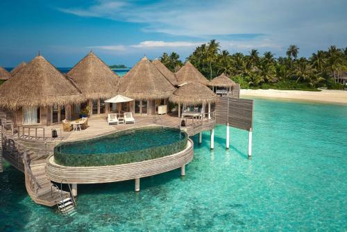 a resort in the ocean with a pool in the water at The Nautilus Maldives in Baa Atoll