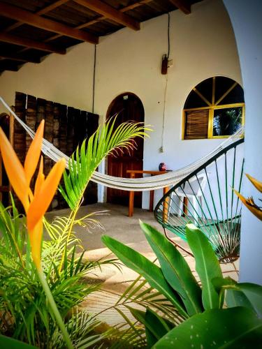a house with a spiral staircase in a room with plants at Casa pájaros- Habitacion Quetzal in Troncones