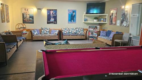 a living room with couches and a pool table at Sunraysia Stays in Mildura