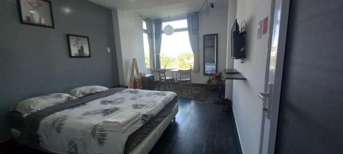 a bedroom with a bed in a room with a window at Thung Lũng Mơ - Dream Valley in Khu Chi Lăng