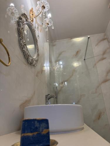 a bathroom with a mirror and a white sink at STEMA Kalymnos in Kalymnos