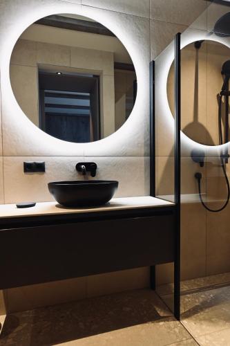 a bathroom with a sink and a mirror at ALOHA Suites - Alp LOdge HAus in Haus im Ennstal