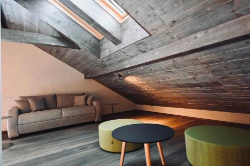 a living room with a couch and a table at ALOHA Suites - Alp LOdge HAus in Haus im Ennstal