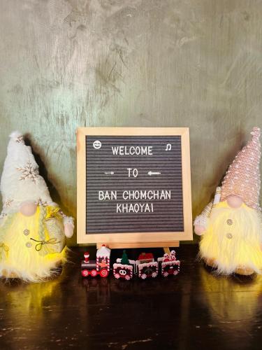 two stuffed animals are standing next to a sign at Ban Chomchan Pool Villa Khaoyai in Ban Tha Chang