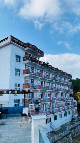 a large white building with balconies on it at Mountain Vista Retreat in Nagarkot