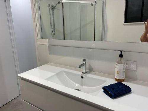 a white sink in a bathroom with a mirror at Family size tropical oasis retreat netflix wifi in Redlynch