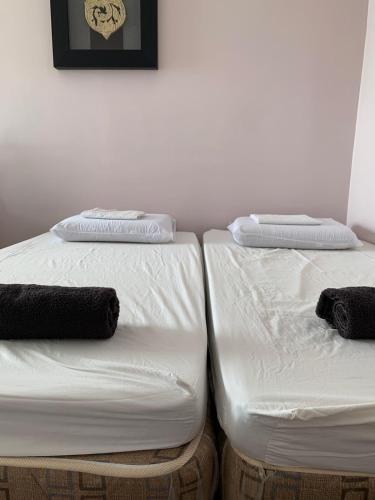 two beds sitting next to each other in a room at Germaroze in Oslob