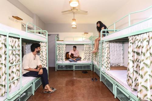 a group of people sitting on bunk beds at Hostel Mantra in Mumbai