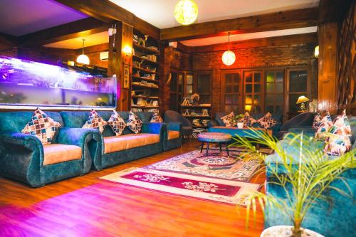 a living room with couches and tables in a room at Mountain Vista Retreat in Nagarkot