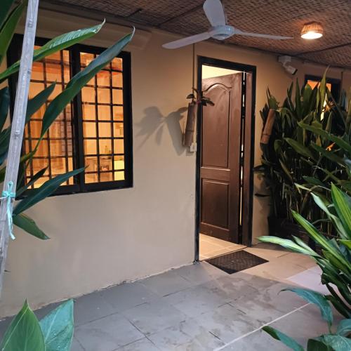 an open door to a house with plants at Siem Reap Homesteading in Siem Reap