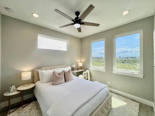 a bedroom with a bed with a ceiling fan at Modern Sanctuary in Saint Augustine in St. Augustine