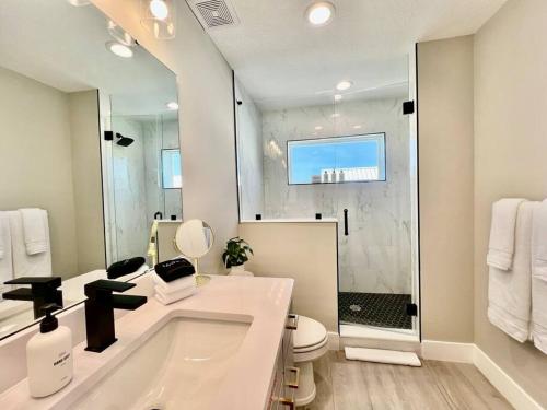 a bathroom with a tub and a toilet and a shower at Modern Sanctuary in Saint Augustine in St. Augustine