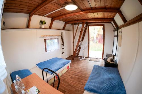 a small room with two beds and a table at Kemp Sluníčko in Doksy