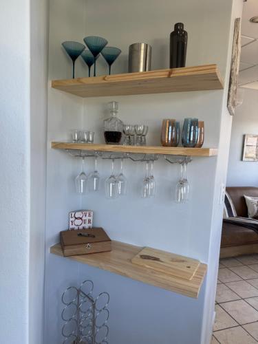 a room with shelves with wine glasses on it at Windpomp Self Catering in Paarl