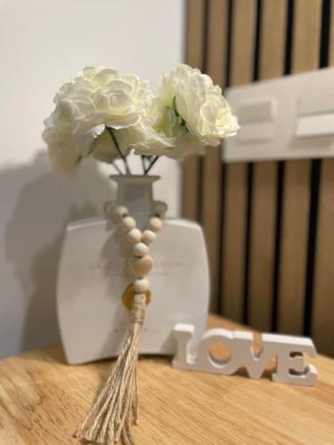 a vase with white flowers on top of a table at Cabosun in El Cabo de Gata