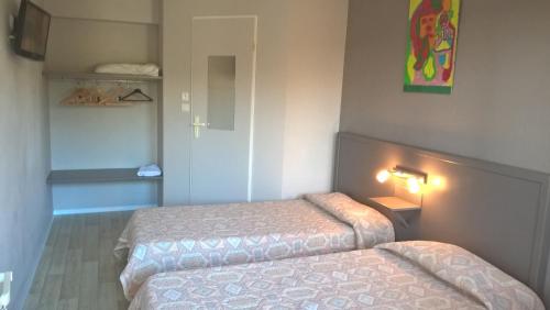 מיטה או מיטות בחדר ב-Riv'Hotel