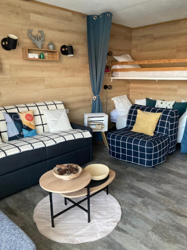 a living room with two couches and a table at Studio cosy 5 personnes aux pieds des pistes. in Le Dévoluy