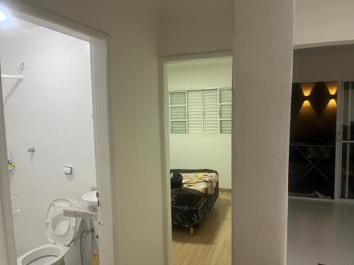 a bathroom with a sink and a toilet in a room at Casa condomínio jardim Moncoes in Maringá