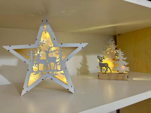 a wooden star on a table with a christmas ornament at Villa Azzurro Blu in Lignano Sabbiadoro