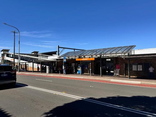 a bus stop on a city street with a road at Alison's central apartment in Cabramatta