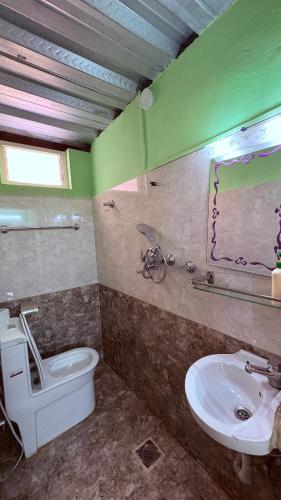 a bathroom with a white toilet and a sink at Wander Thirst in Kathmandu