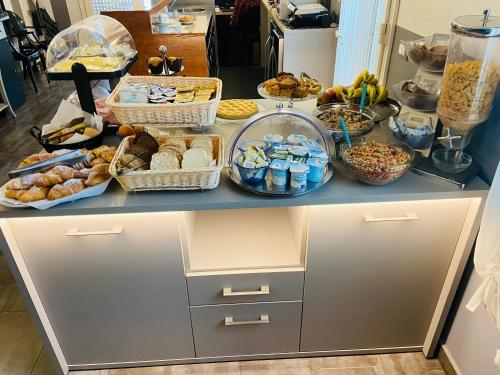 a counter with many baskets of food on it at Hotel Volta in Padova