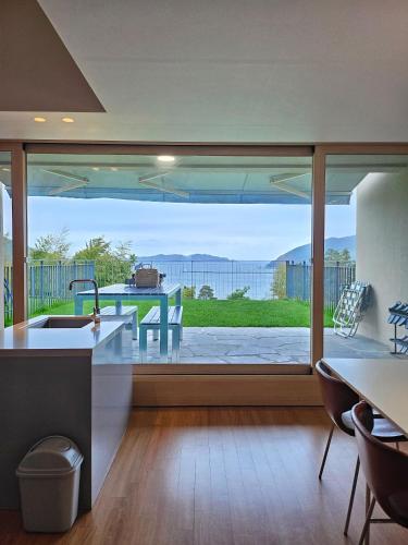 a kitchen with a large window with a view of the ocean at Hotel SANG SANG & Private SANG SANG POOL VILLA in Geoje 
