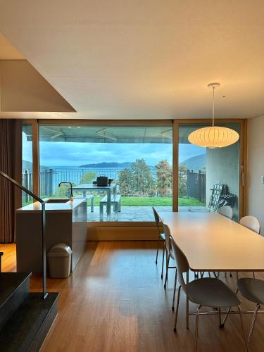 a dining room with a table and chairs and a large window at Hotel SANG SANG & Private SANG SANG POOL VILLA in Geoje 