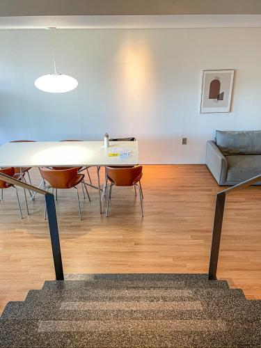 a living room with a table and chairs and a couch at Hotel SANG SANG & Private SANG SANG POOL VILLA in Geoje 