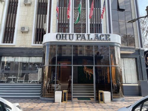 a man standing in front of an office building at Ohu Palace in Fergana