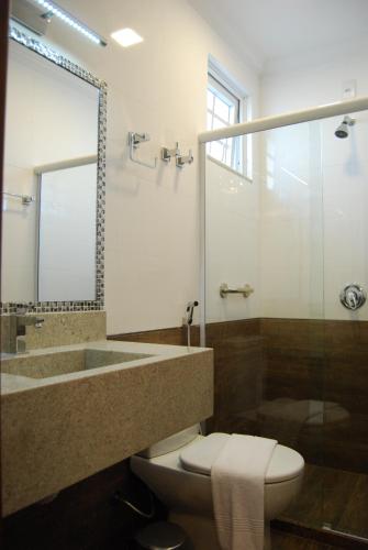 a bathroom with a sink and a toilet and a shower at Pousada Bahia Pelô in Salvador