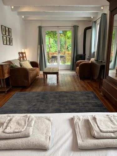 a living room with a couch and a table at Le Petit Verger Gîte in Bonnes