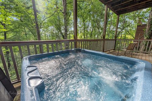 a hot tub on the deck of a cabin at Hey Diddle Diddle cabin in Pigeon Forge