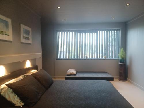 a bedroom with a bed and a large window at B & B Fish World in Vlissingen