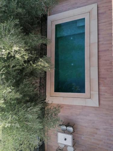 an overhead view of a bench next to a window at Riad Tazawa in Ibrahene