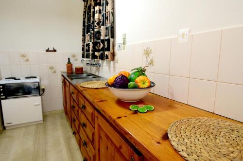 a bowl of fruit on a counter in a kitchen at Golden Apartments in Agios Nikolaos