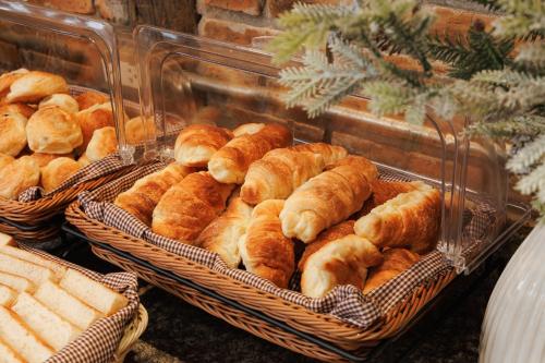 a bunch of loaves of bread in baskets at Le Charcoa Hotel in Chiang Mai