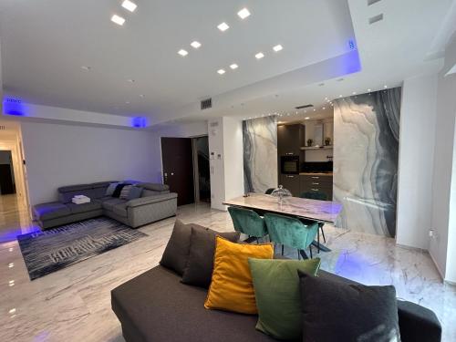 a living room with a couch and a table at Blumoon boutique in Andria