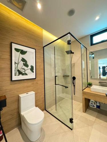 a bathroom with a toilet and a shower and a sink at Swimming Pool Homestay in Kuah