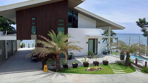 a house with a view of the ocean at Costa Anita Seaside Resort in Cebu