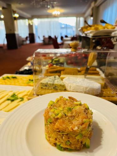 a white plate with a piece of food on a table at Hotel Plaza in Craiova