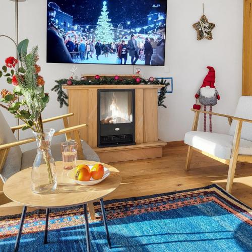 a living room with a table and a fireplace at Ferienwohnung Parsenn Peaks Panorama in Davos