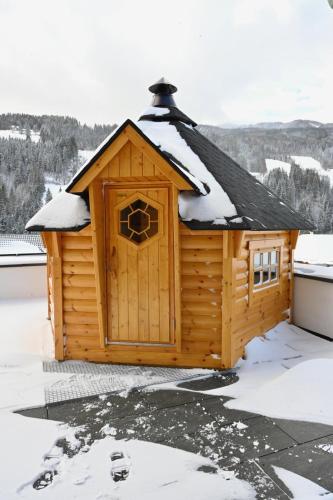 a cabin with a roof covered in snow at Sun Chalet in Schladming