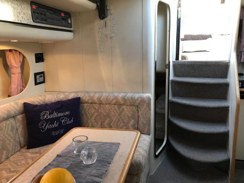 a living room with a couch and a stair case at Prinsessan i Lilla Bommen in Gothenburg