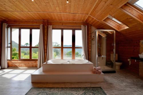 a large bathroom with a tub and a shower at Natural Home Tarifa in Tarifa