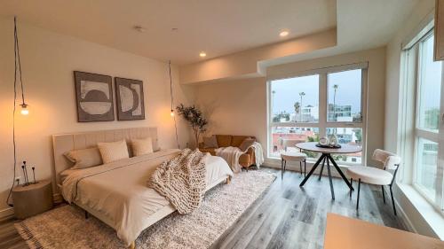 a bedroom with a large bed and a table at Lovely Studio in heart of Hollywood in Los Angeles