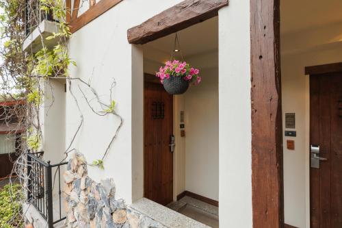 a door to a house with a basket of flowers at Le Charcoa Hotel in Chiang Mai