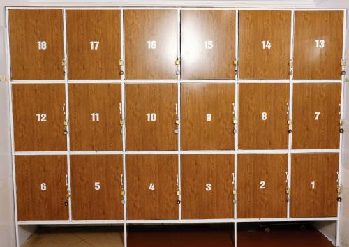 a bunch of wooden lockers with numbers on them at Lazy Cat Homestay - Motorbikes Rental & Tours in Ha Giang