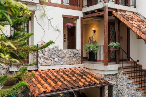 an exterior view of a house with a tile roof at Le Charcoa Hotel in Chiang Mai